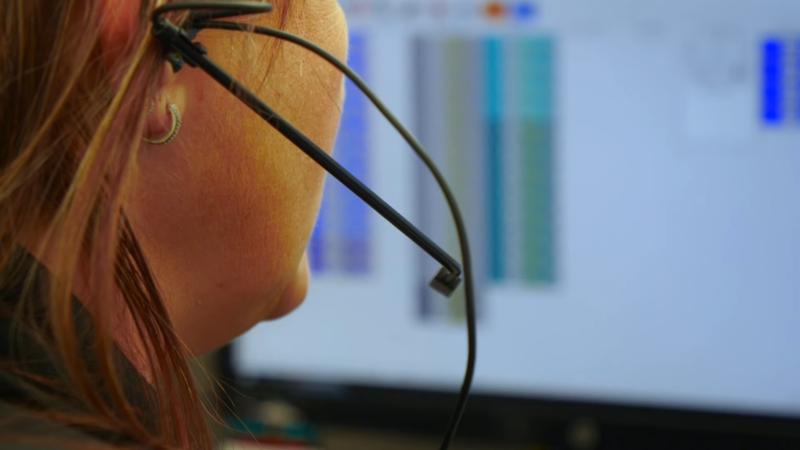 A 911 Dispatcher with A Headset Handling Emergency Calls