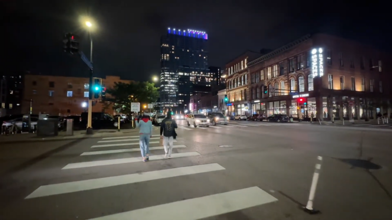 Two People Are Crossing a City Street at Night in Minnesota