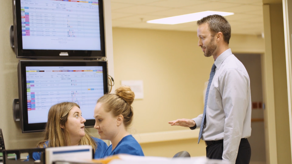 A Medical and Health Services Manager Discusses with Staff Members