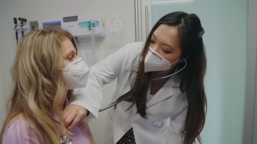 A Nurse Practitioner Listens to A Patient's Heartbeat Using a Stethoscope During a Checkup