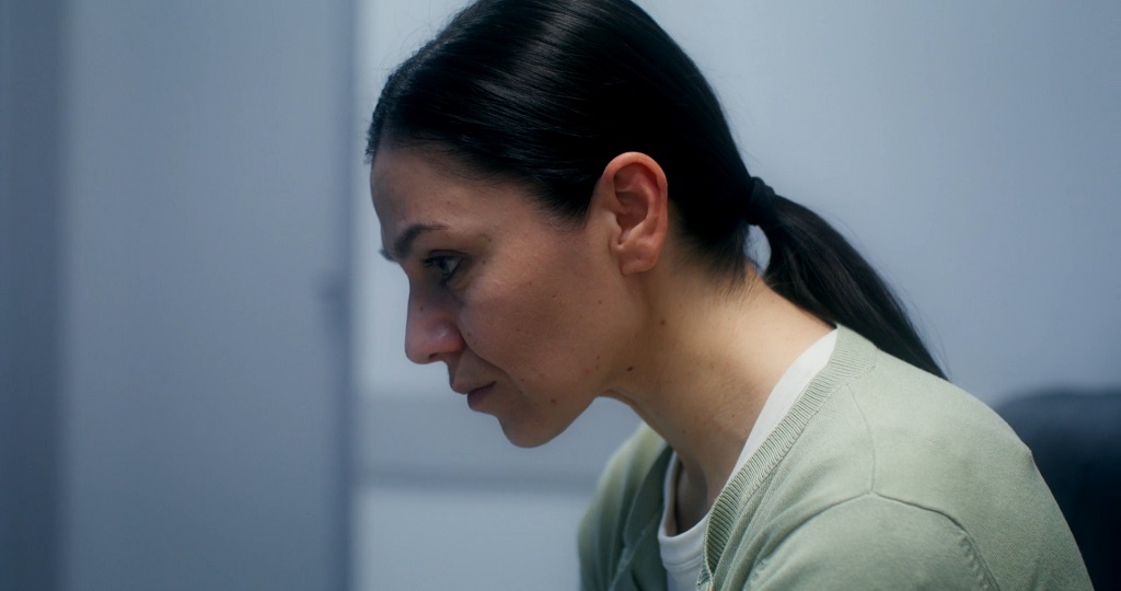 Immigrant woman looking distressed, worried about legal status and accessing help