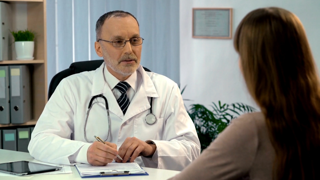 A doctor speaks with a patient during a consultation at a medical office