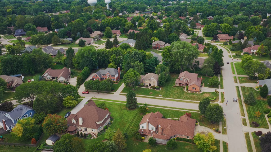 Aerial view of Beavercreek, Ohio, showing suburban neighborhoods with large homes, tree-lined streets, and spacious green yards