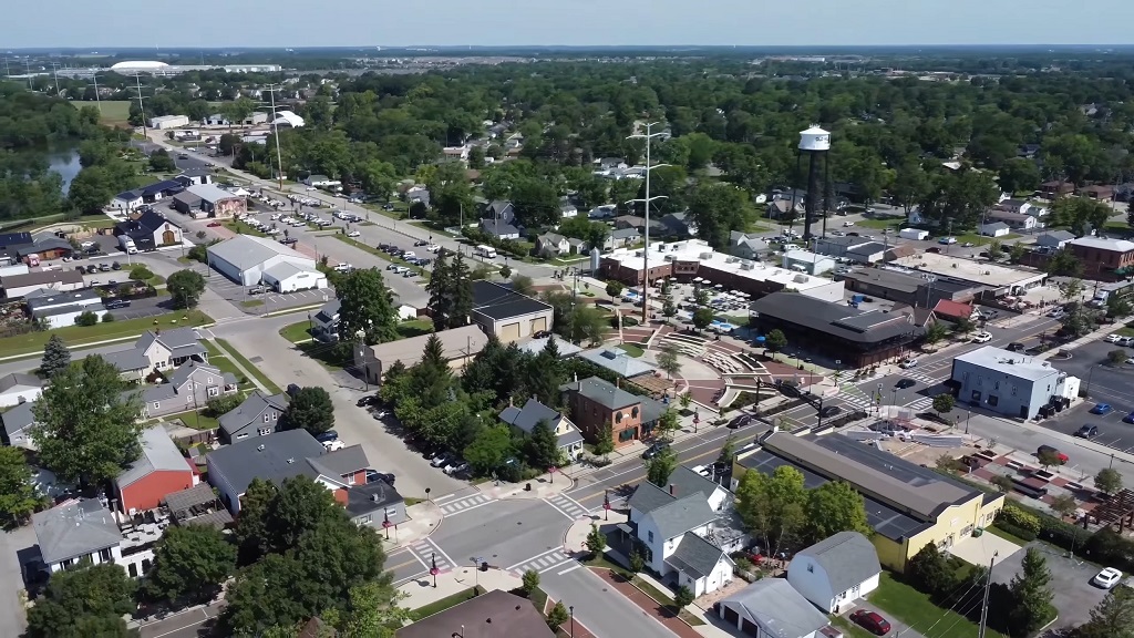 Aerial view of Hilliard, Ohio, showing a mix of residential neighborhoods, small businesses, and the city’s amphitheater with a water tower in the background