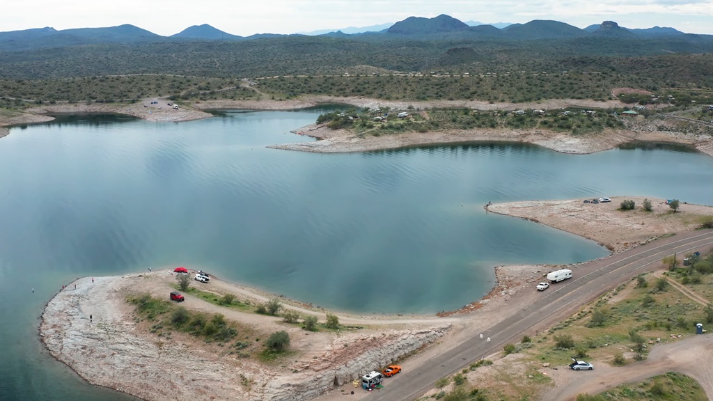Aerial view of Lake Pleasant with boats, campers, and people enjoying the shoreline
