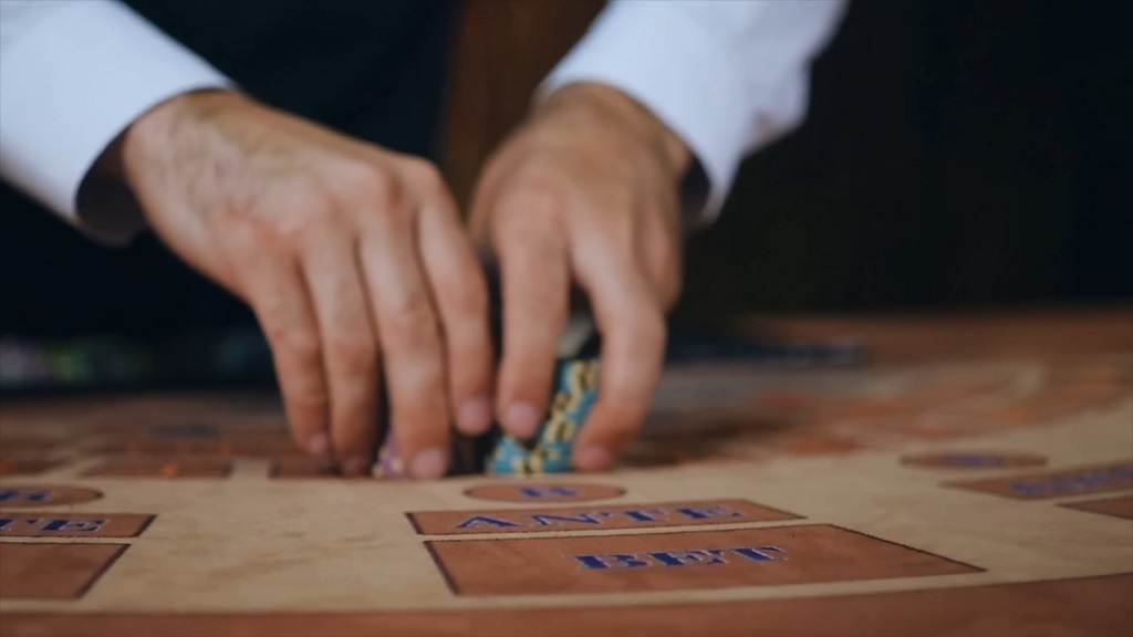 Casino dealerโs hands arranging poker chips on a game table, symbolizing how gambling activity in Las Vegas continues despite fewer tourists