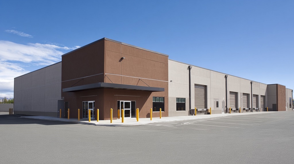 Exterior view of a large modern warehouse building under a clear blue sky