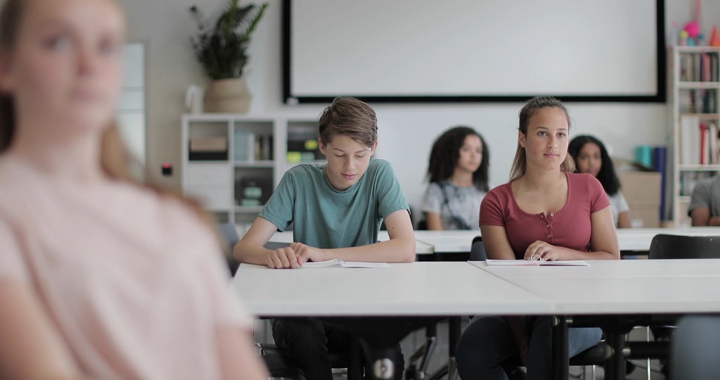Middle school students seated at desks during a classroom lesson