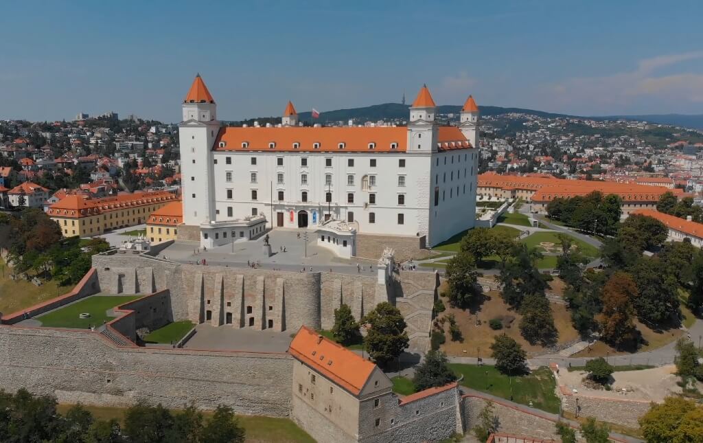 Aerial view of Bratislava Castle with its four corner towers, standing on a hill above the city in Slovakia