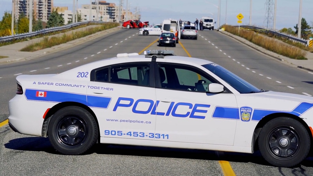 Police vehicle blocking a Canadian roadway during an incident, symbolizing strong public trust in enforcement and community safety priorities