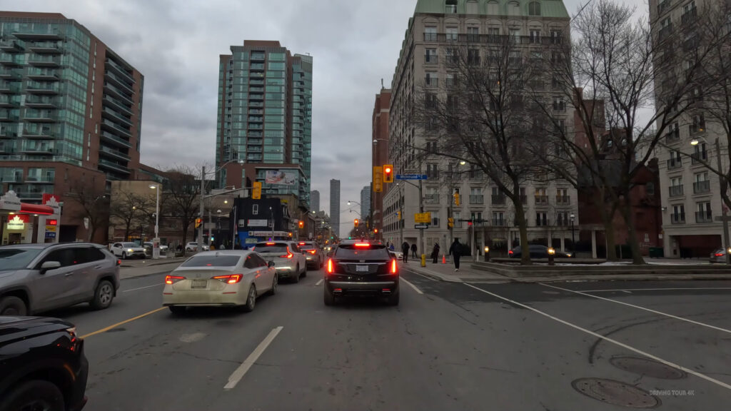 Canadian city street with organized traffic flow and visible signaling, reflecting stable safety performance and managed urban mobility
