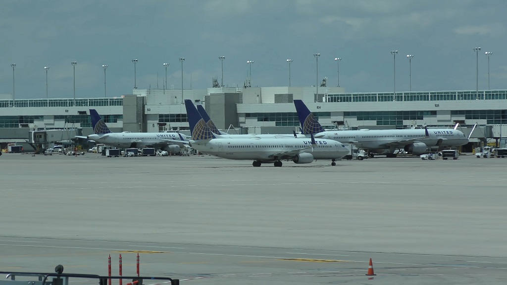 United Airlines aircraft positioned at gates at Denver International Airport with terminal buildings in the background