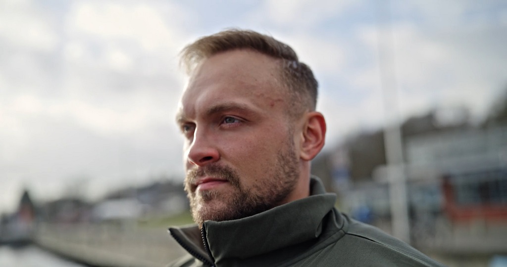 Veteran standing outdoors looking ahead, representing career transition, resilience, and employment opportunities after military service