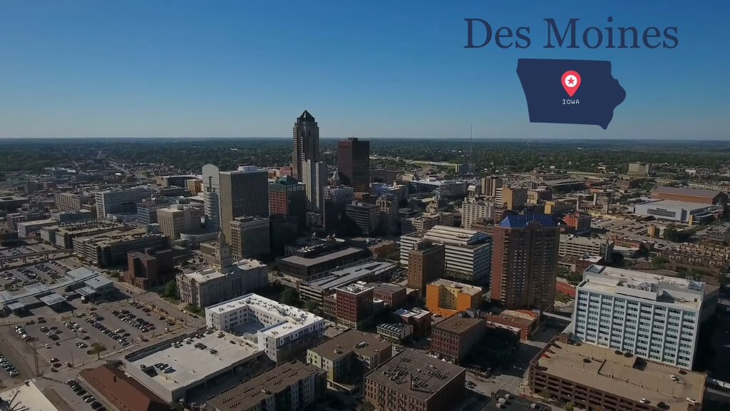 Aerial view of Des Moines city center showing office towers, grid streets, and surrounding residential areas
