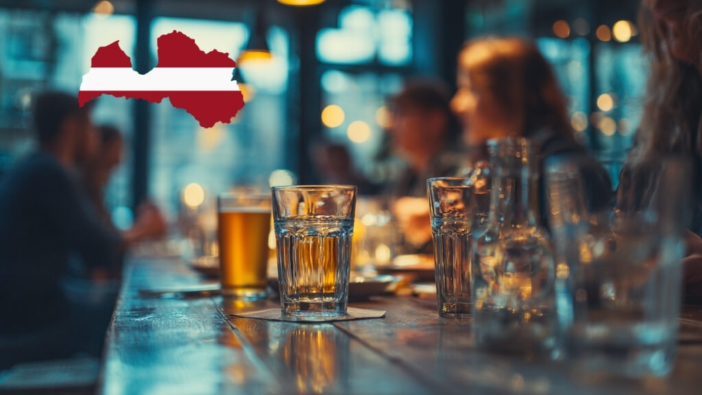 Beer and spirits glasses placed on a bar table in a Latvian nightlife setting