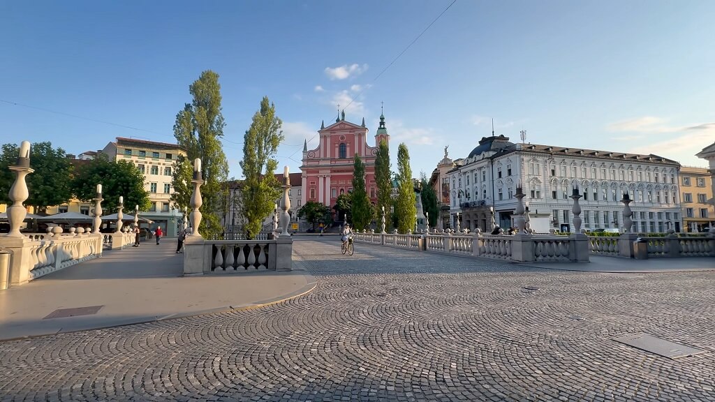 Early evening view of Ljubljana’s Prešeren Square with the pink Franciscan Church of the Annunciation