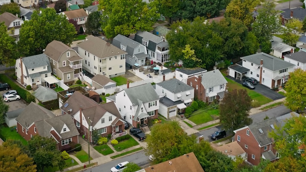 Aerial view of a suburban residential neighborhood with detached houses, tree-lined streets, and neatly maintained yards, typical of Pennsylvania housing areas