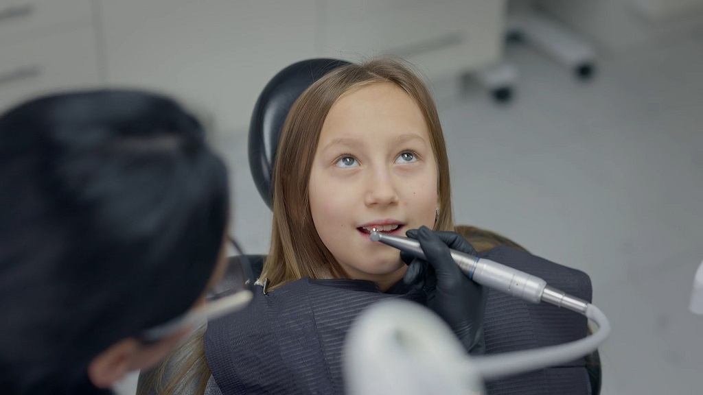 Child receiving a dental examination in a clinic, highlighting preventive oral healthcare