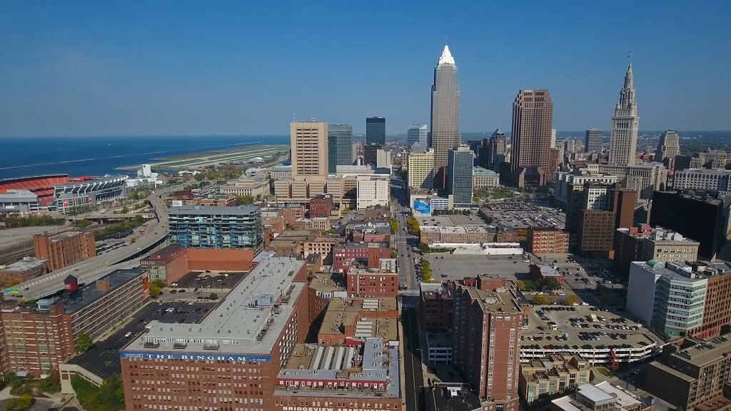 Aerial view of a major Ohio city showing downtown buildings, lakefront, and surrounding neighborhoods