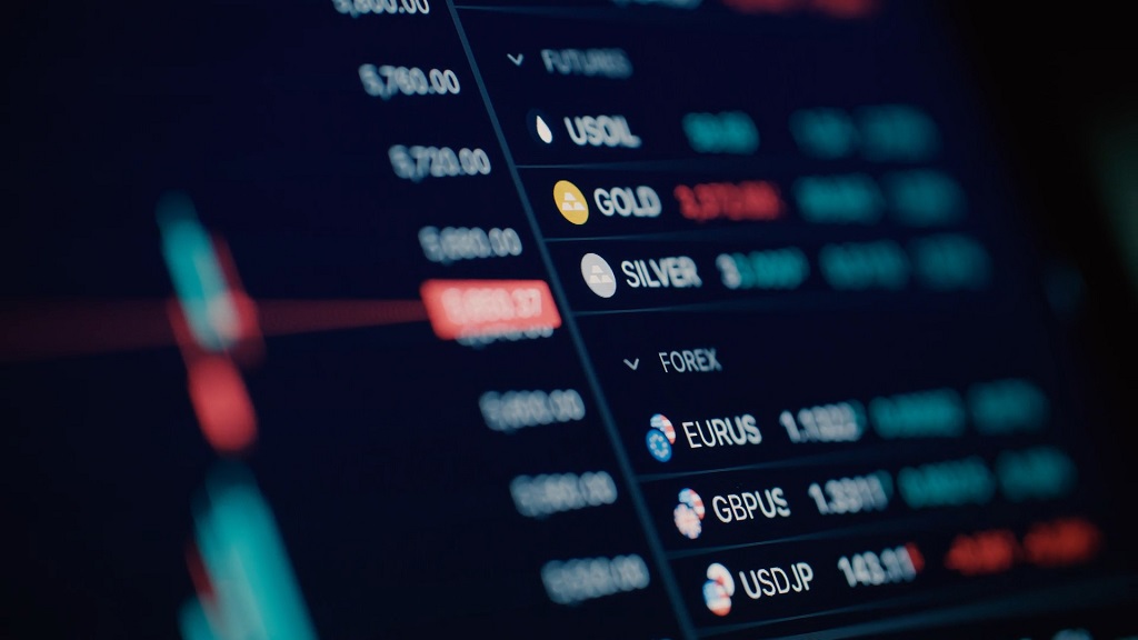 Close-up of a digital trading dashboard showing forex currency pairs and commodity prices including gold and silver