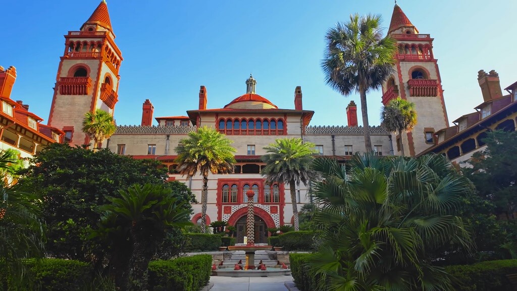 Historic courtyard and Spanish Renaissance architecture of Flagler College in St. Augustine surrounded by tropical landscaping