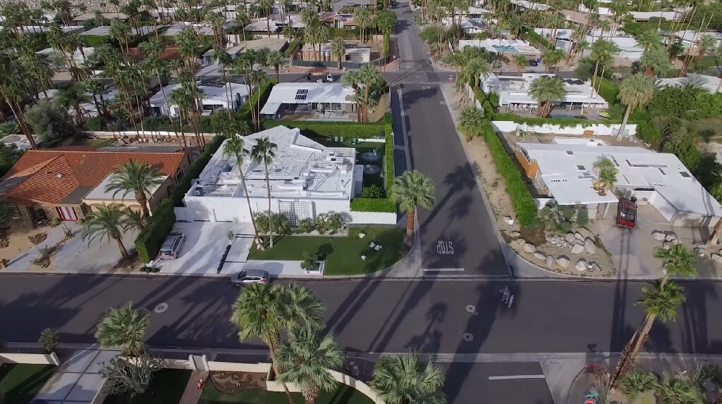 Aerial view of a quiet residential neighborhood in St. Augustine with palm trees, single-story homes, and well-kept lawns