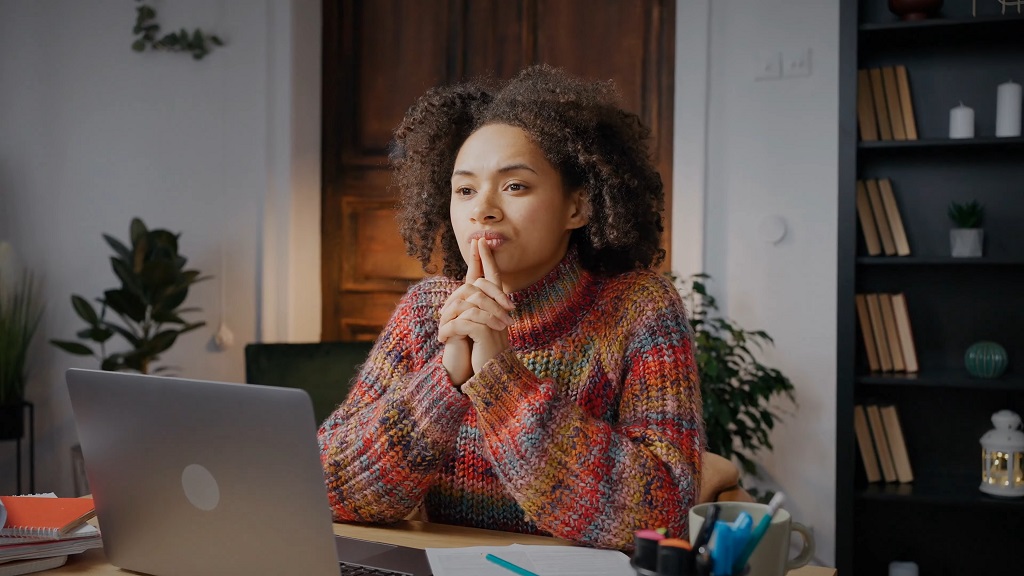 Parent reviewing housing, school, and cost-of-living information while planning family decisions at home