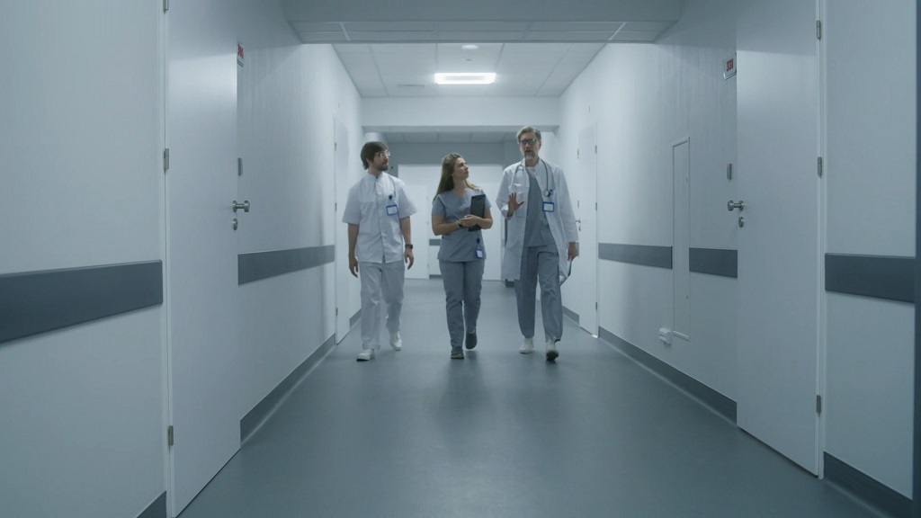 Medical staff walking together down a hospital corridor, representing healthcare operations and clinical teamwork
