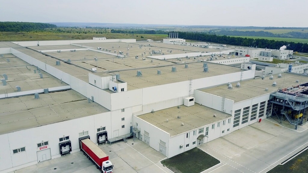 Aerial view of a large-scale industrial manufacturing facility with loading docks and surrounding infrastructure
